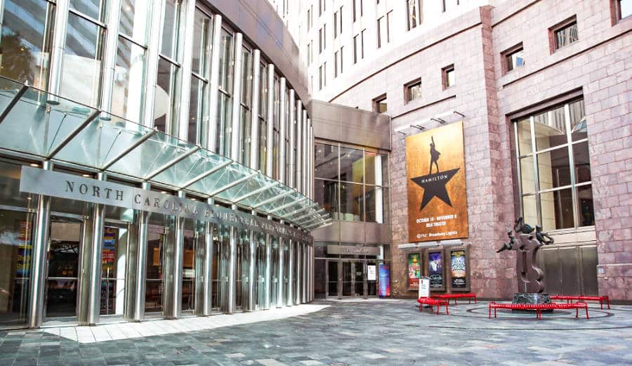 View of the floor to ceiling glass wall and front entrance of Blumenthal Performing Arts Center