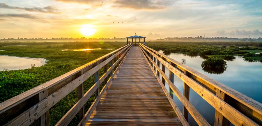 View of the sunrise on a boardwalk in Beaumont, Texas