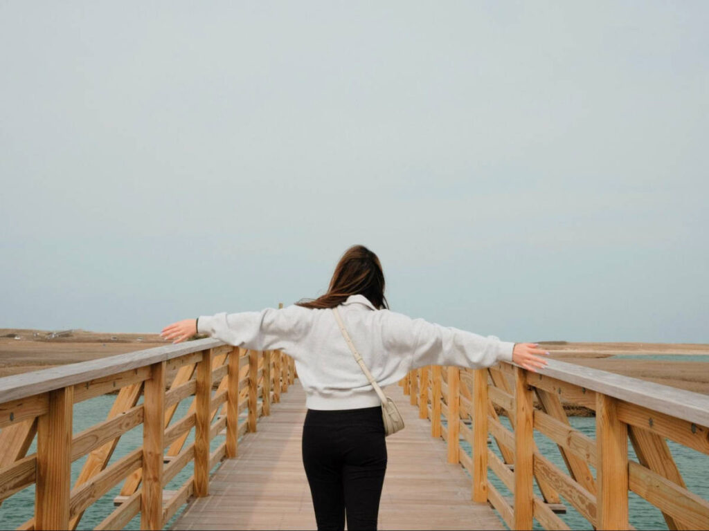 The author Samantha Tran enjoying the view from a boardwalk in Cape Cod
