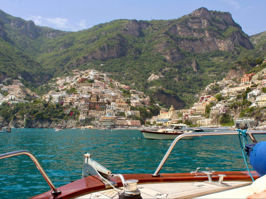 A boat on the water, pulling up to Positano.