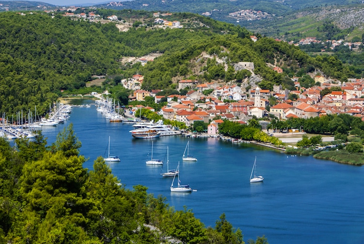 Sail boats rest in the harbor off a small Croatian town