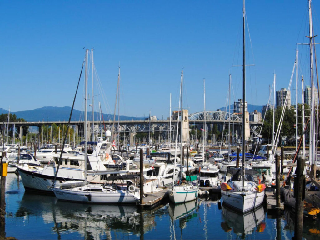 View of boats in Vancouver's harbor under a clear blue sky