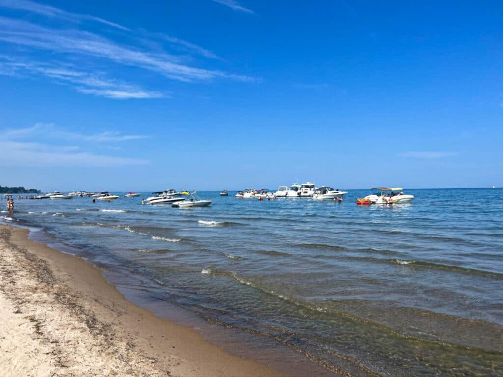 View of the boats sailing on Lake Ontario with a clear blue sky in the background