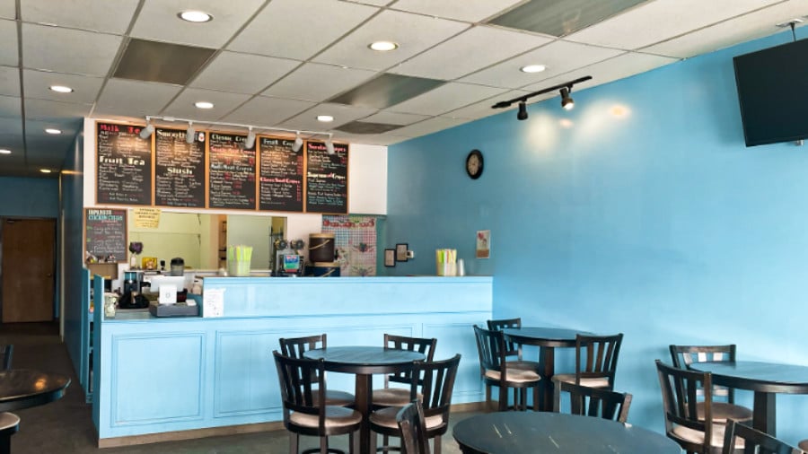 View of the baby blue interior and counter of Boba & Crepes