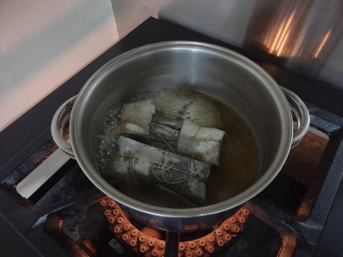 The pasteles in the pan with boiling water