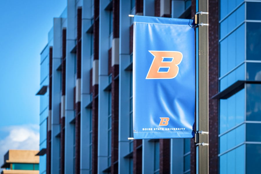 Boise State University's "B" logo banner flag in front of the campus building