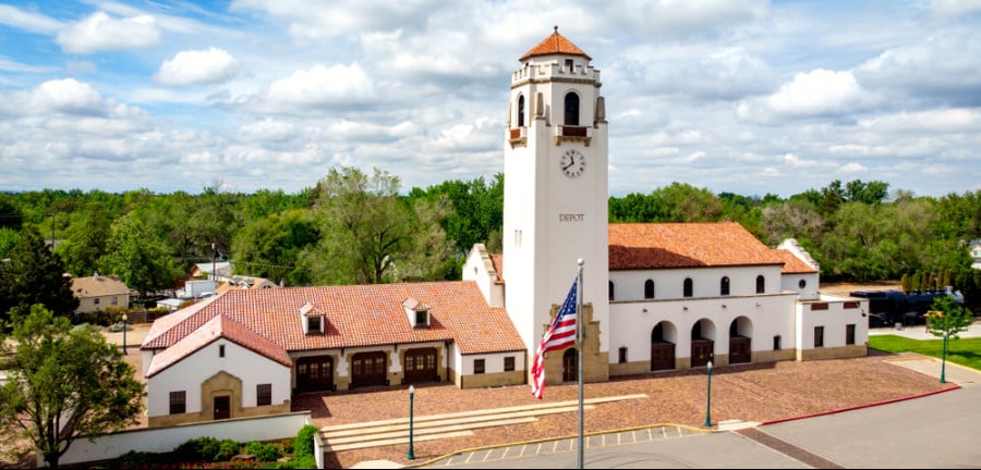 A US flag waved by the wind in front of Boise Train Depot