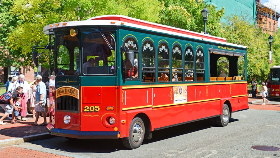 A red trolley in the middle of the city