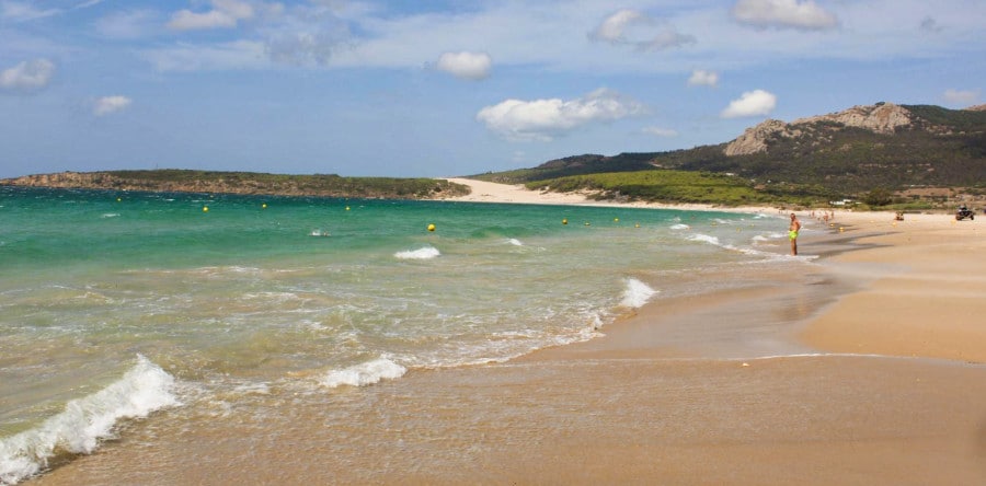 Turquoise blue beach water and a view of Africa from the distance in the coastal town of Bolonia.