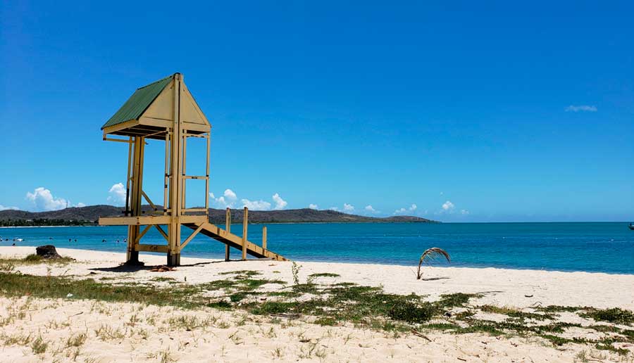 View of the blue water in Boquerón Beach and the clear blue sky over it