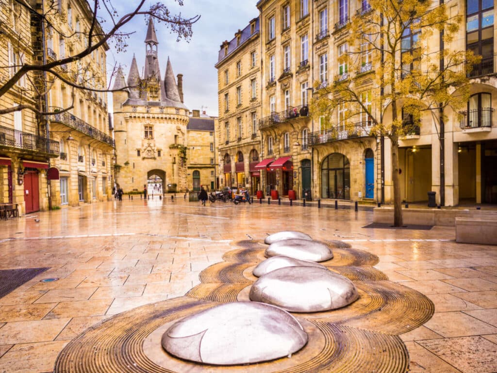 View of the old town gate in the middle of the buildings in Bordeaux