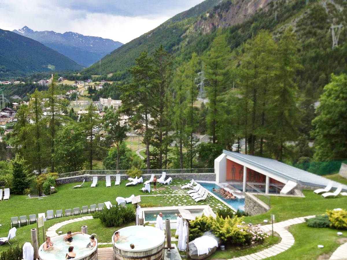 A serene spa area with massage tables, jacuzzi, and lounge chairs at Bormio