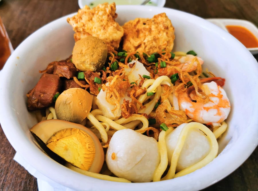 A bowl of homemade egg noodles with chicken and shrimp