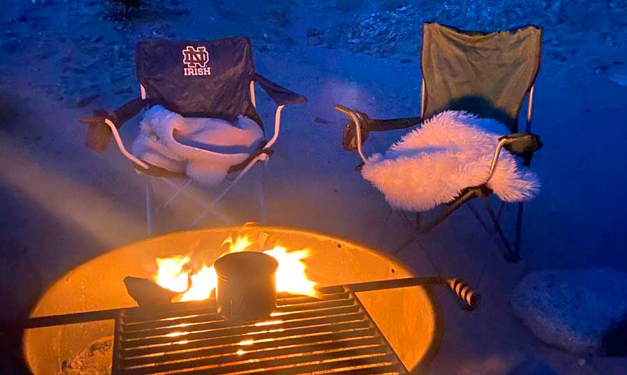 A camp fire and two two camping chairs near it in Borrego Springs Campground