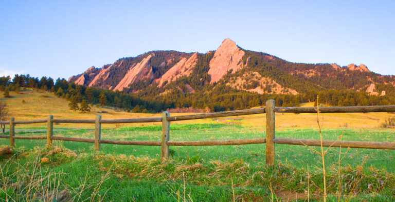 Panoramic view of Boulder Flatirons at sunset