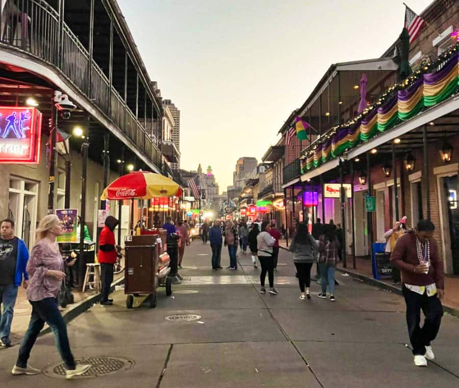 View of the crowd wandering the Bourbon Street with shops and street vendors around
