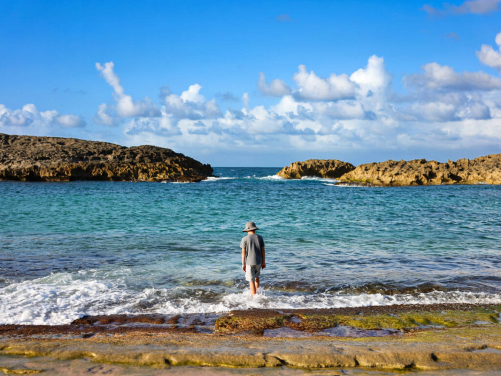 A boy enjoying the water and the picturesque view at Mar Chiquita Beach
