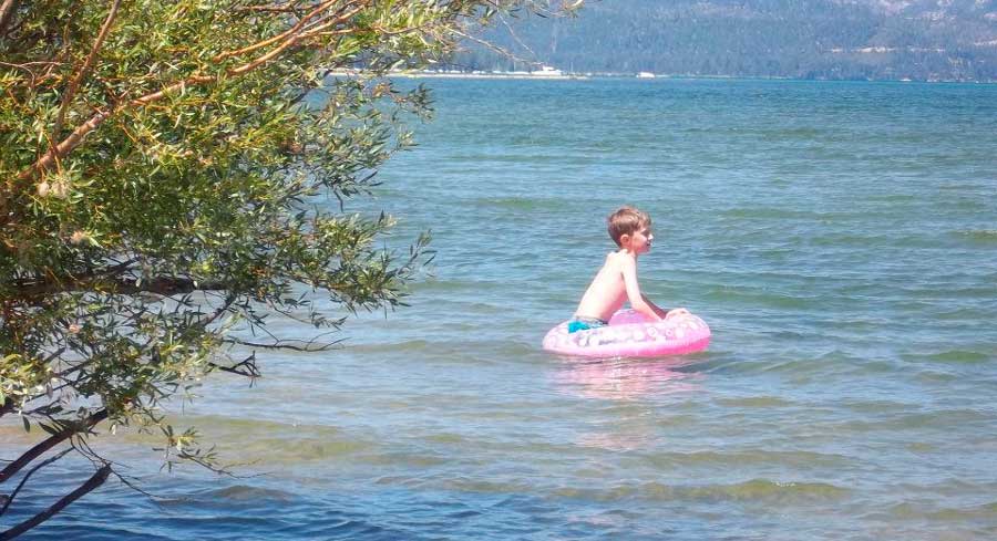 A boy enjoying his day on a water floater