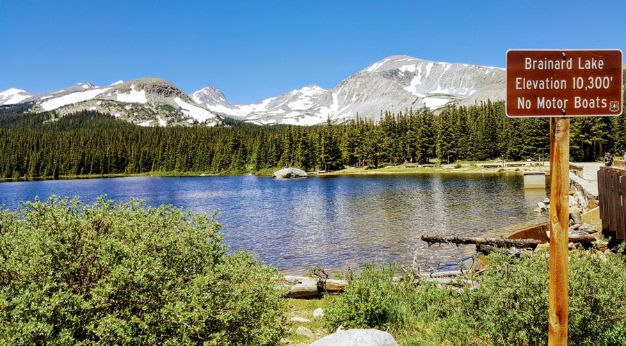 View of the Brainard Lake and a snowy mountain range from the background