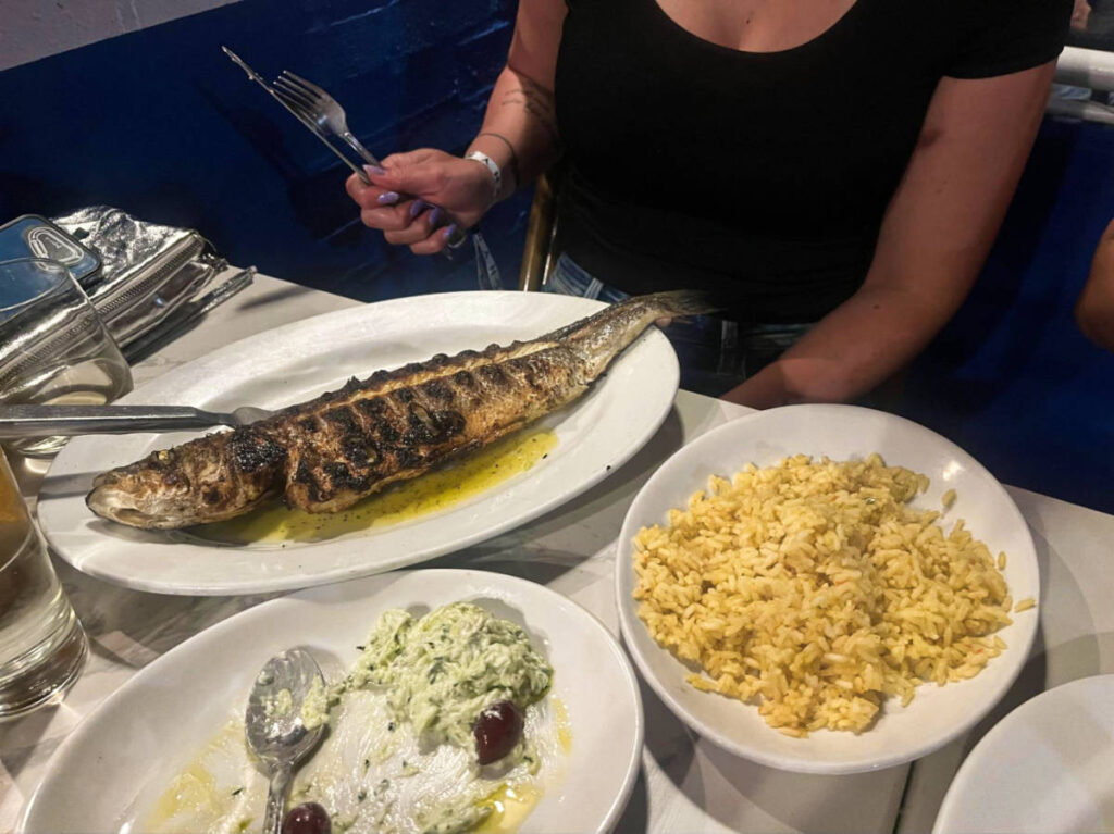 A huge plate of branzino and other foods from Taverna Kyclades