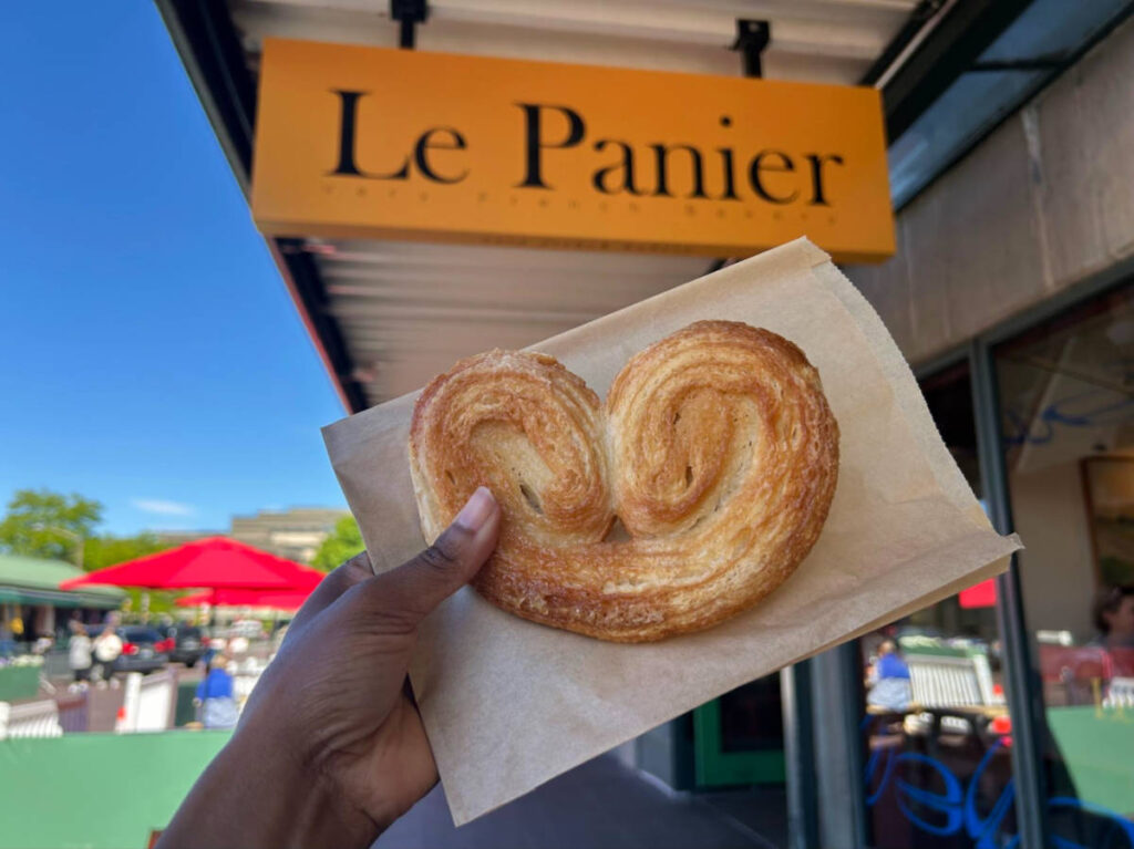 Holding up a bread from Le Panier