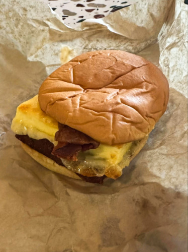 Closeup look of the egg and meat on the breakfast sandwich from Allez Cafe