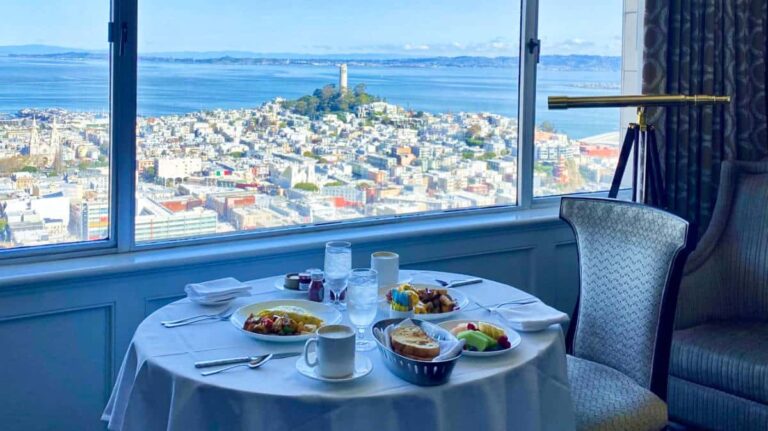 A breakfast table at the Fairmont hotel with a scenic view of San Francisco from the glass window