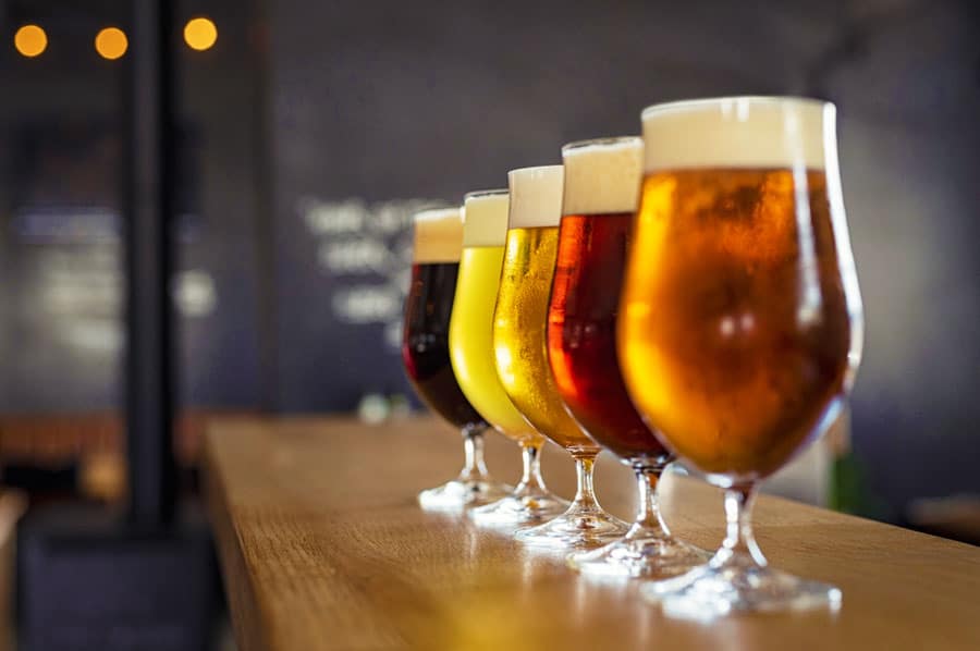 Different craft beers lined in a wooden bar