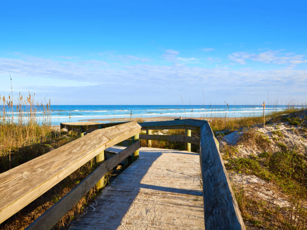 A footbridge leading to Atlantic Beach on a sunny day