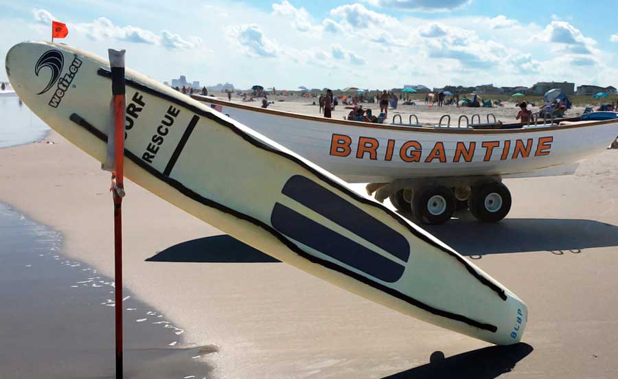 Boats and surfboard in Brigantine Beach