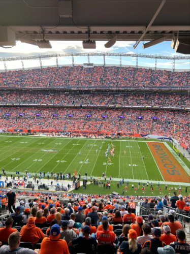 The Broncos fans wearing orange shirts at the Empower Field at Mile High