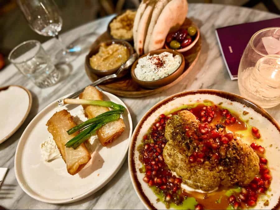 Three sharing plates of different Mediterranean food at Brother Marcus Borough