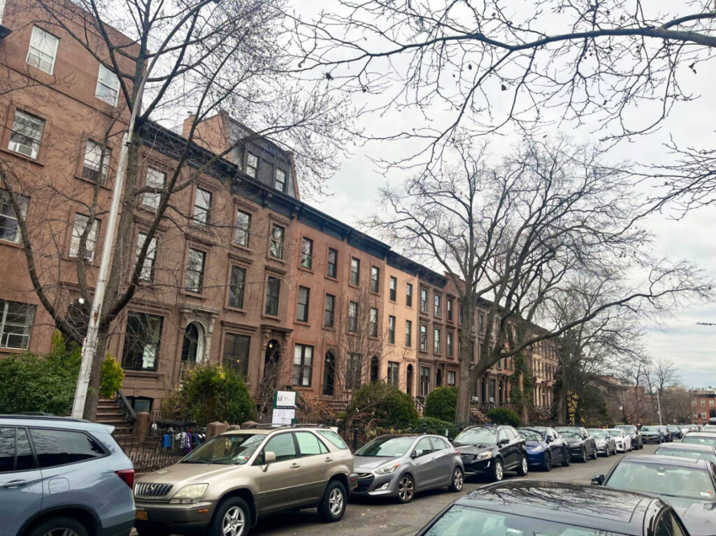 View of the Brownstones lining along the street in Brooklyn during winter
