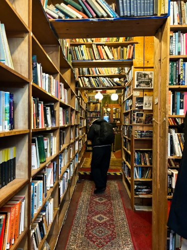 A man browsing the books inside the Armchair Books