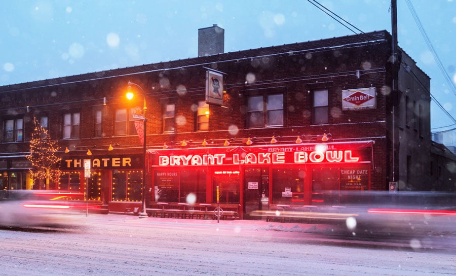 The Bryant Lake Bowl & Theater sign illuminated at night during winter