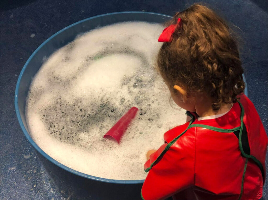 Author Claudicet Pena's daughter enjoying the Bubble Table Room in the Children’s Museum