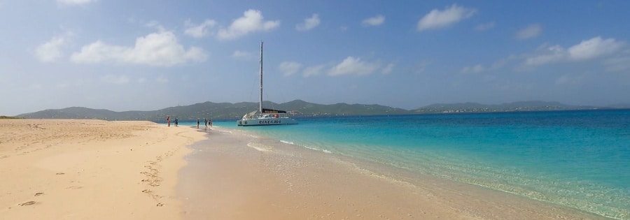 Serene view of the calm sea and people waiting for the boat in Turtle Beach on Buck Island