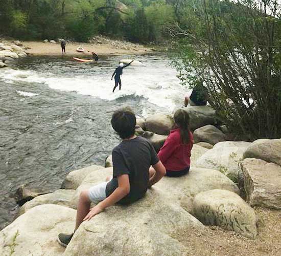 View of people trying river surfing in Buena Vista Whitewater Park