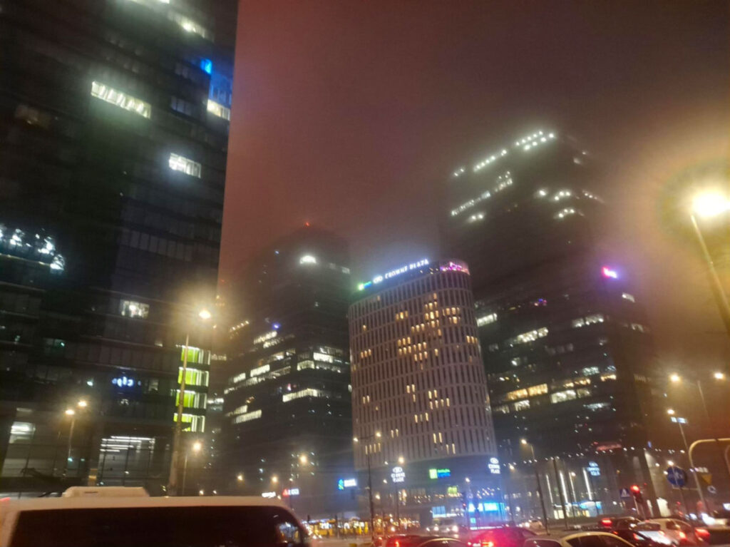 Night scene in Wola featuring high rise buildings