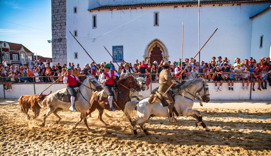 Crowd watching a bullfighting with men on horses in Alcochete