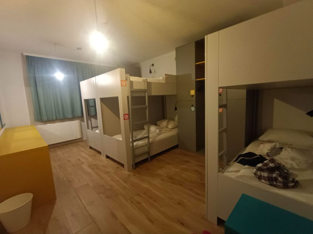 Interior of a room with room with a bunk bed setup and a desk