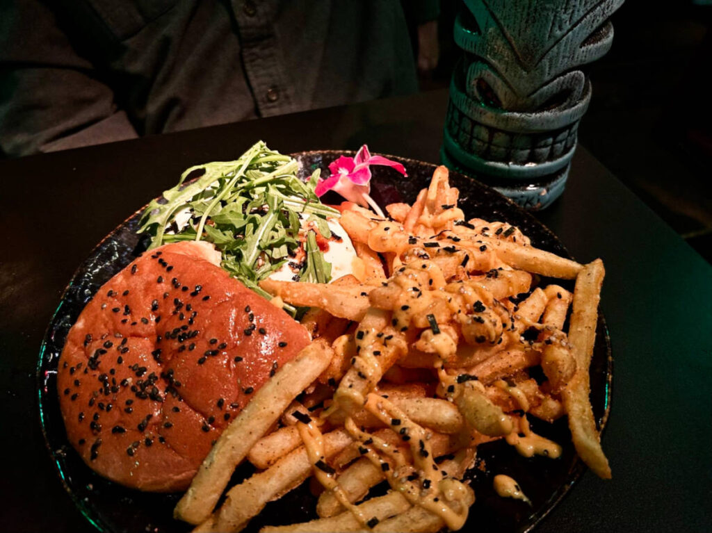 A plate of burger and fries from Adrift Tiki Bar