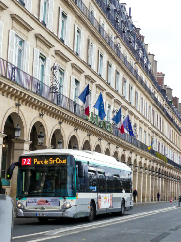 A bus driving along the old buildings in France