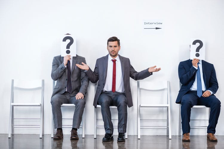 Businessmen sitting with question mark sign