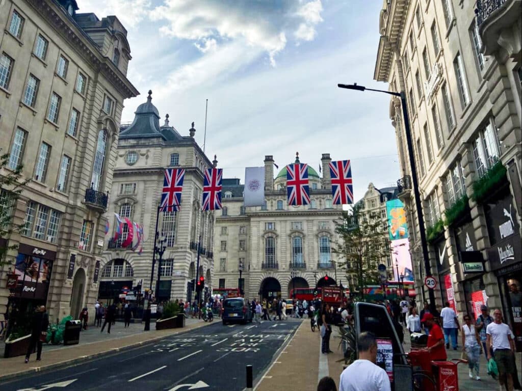 View of the people, double-decker buses, and buildings at the busy street in Oxford Circus