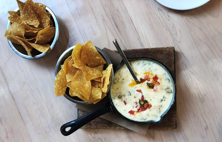 View of nachos and dip on a table in Butchertown Hall
