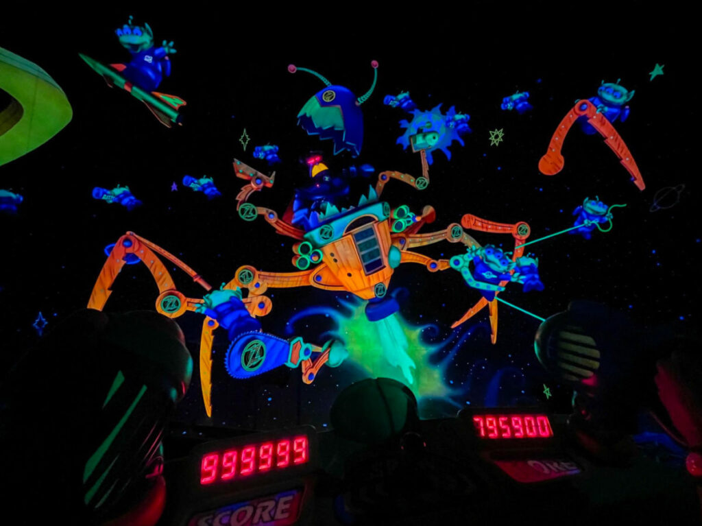 Robots and aliens in a dimly lit room, showcasing the world of Buzz Lightyear's Space Ranger Spin