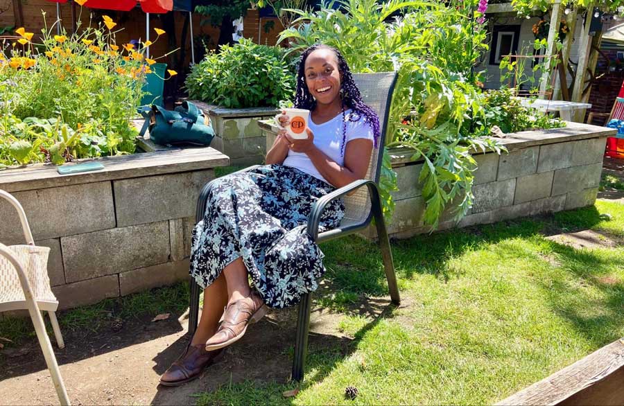 The author enjoying her cup of coffee on the backyard garden of C & P Coffee