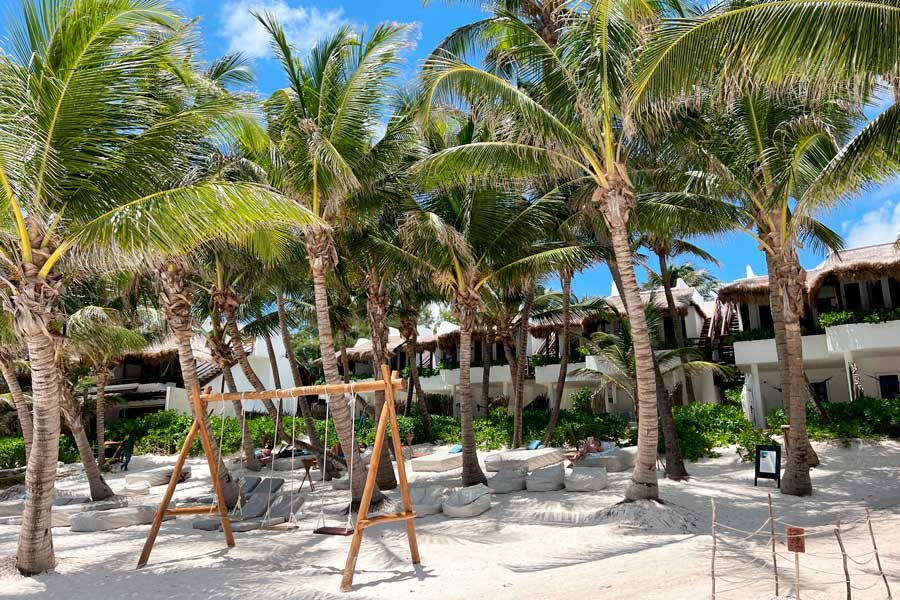 View of a swing on the beach area of Cabañas Tulum Hotel