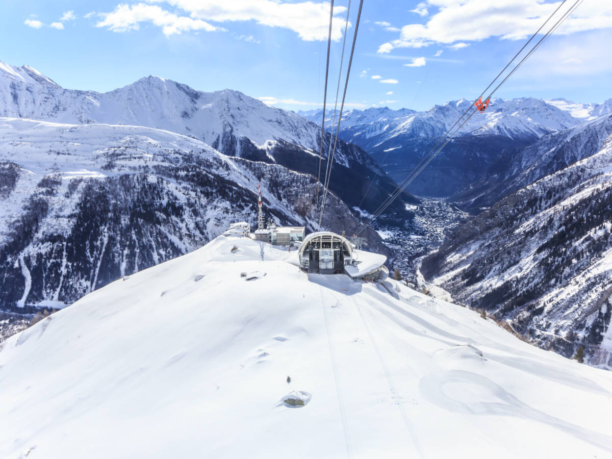 A ski lift surrounded by snow-covered mountains at Courmayeur